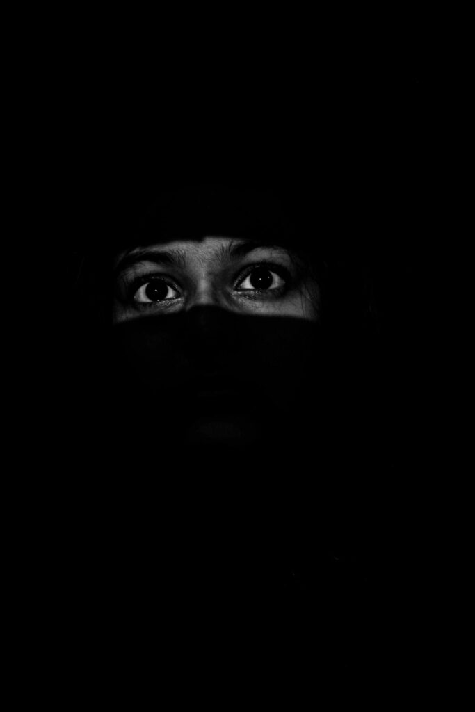 A captivating image of eyes peering from a dark background, conveying mystery.