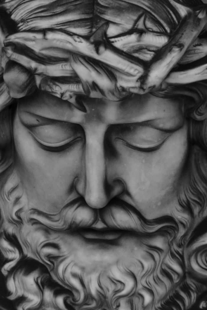 Close-up of a marble sculpture depicting Jesus Christ with a crown of thorns.
